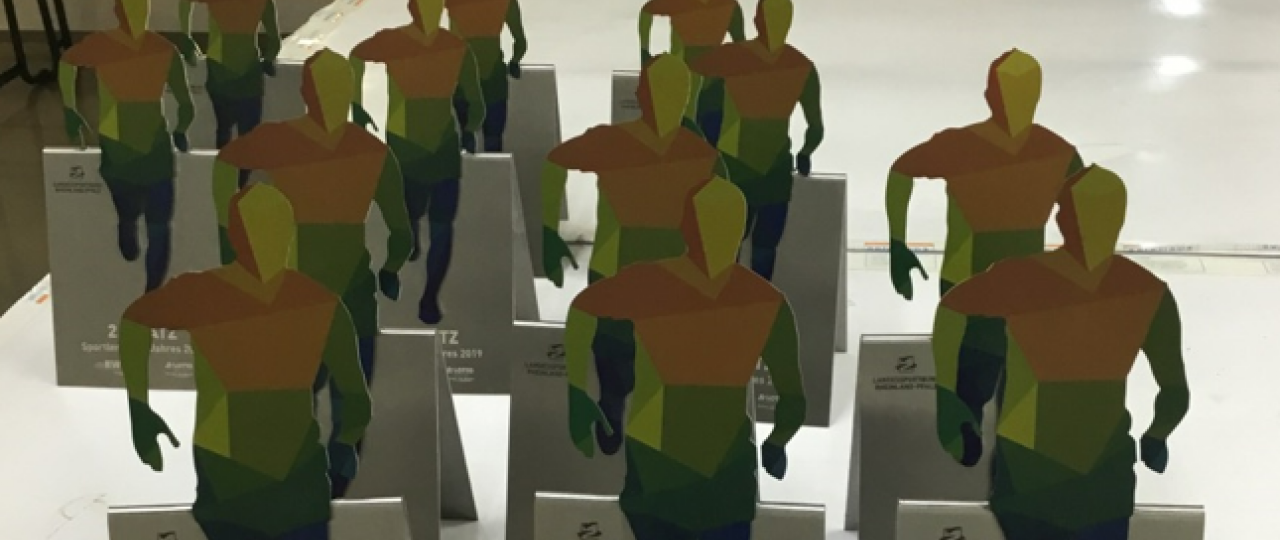 Die bunten Trophäen, die einen Läufer darstellen, werden an die Landessportler*innen vergeben.