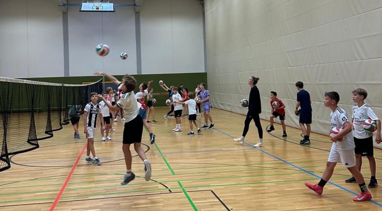 Kinder beim Volleyball in Sporthalle