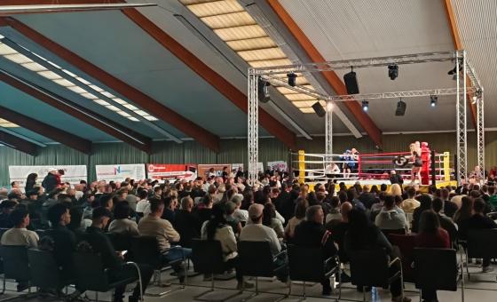 Boxring mit vielen Zuschauern davor sitzend