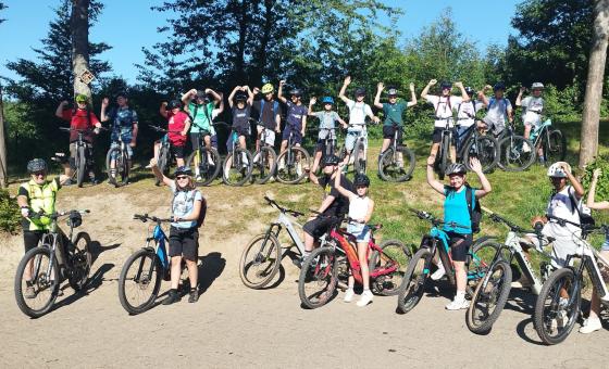 Eine Gruppe von Schüler*innen draußen auf Fahrrädern